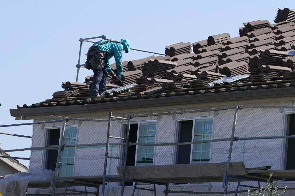 File - Work is performed on the roof of a home under construction in Folsom, Calif. Wednesday, Oct. 12, 2022. Home prices are slowing sharply compared with a year ago and have begun to fall on a monthly basis.(AP Photo/Rich Pedroncelli)