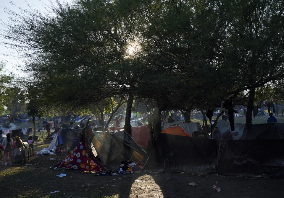 Venezuelan migrants camp alongside a river bank in Matamoros, Mexico, Thursday, Dec. 22, 2022. (AP Photo/Fernando Llano)