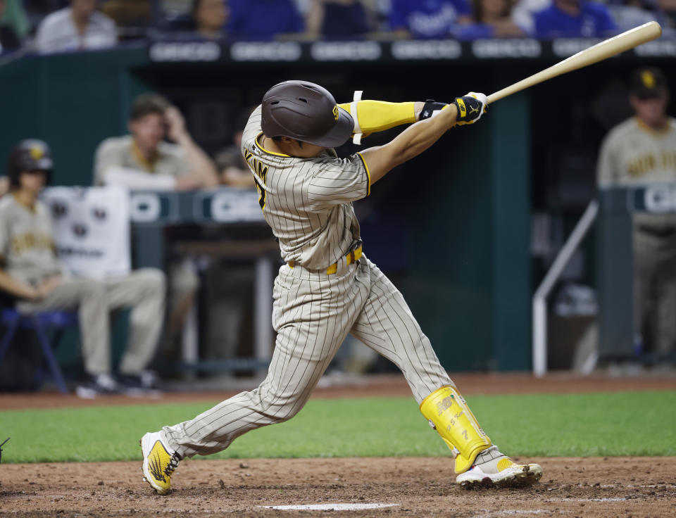 San Diego Padres' Ha-Seong Kim hits a two-RBI double during the seventh inning of baseball game against the Kansas City Royals in Kansas City, Mo., Friday, Aug. 26, 2022. (AP Photo/Colin E. Braley)