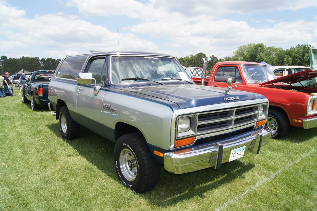 1990 Dodge Ramcharger parked on grass field among other cars.