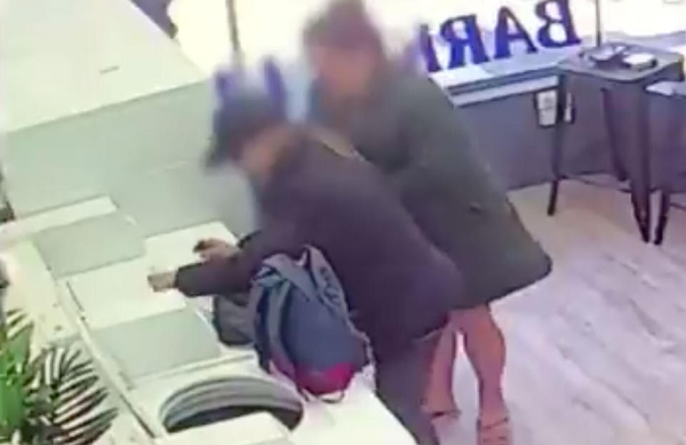 Two people are seen placing drugs on top of a washing machine at Barkly Street Laundromat in Melbourne's suburb of St Kilda.