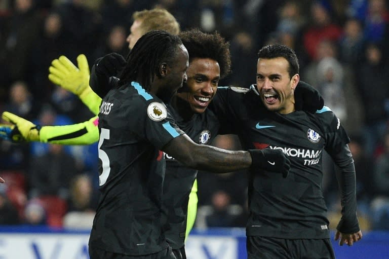 Chelsea's Pedro (R) celebrates with teammates after scoring a goal during their English Premier League match against Huddersfield Town, at the John Smith's stadium in Huddersfield, on December 12, 2017