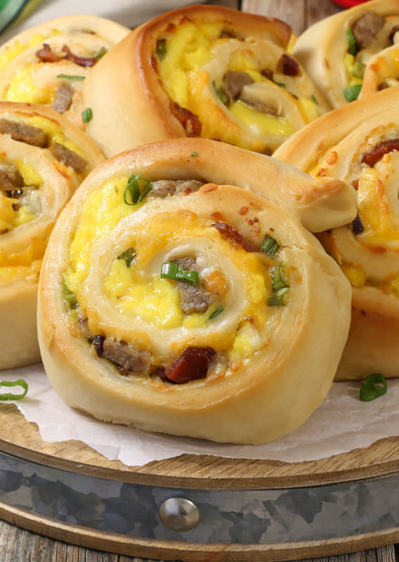 <p>The Slow Roasted Italian</p><p>Cheesy Sausage Breakfast Pinwheels are a simple recipe made with soft and tender bread filled with your favorite breakfast fixins. It's like unrolling a little piece of heaven loaded with smoky bacon, pork sausage, scrambled eggs and ooey gooey cheese!</p><p><strong>Get the recipe: <a href="https://www.theslowroasteditalian.com/2017/07/cheesy-sausage-breakfast-pinwheels-recipe.html" rel="nofollow noopener" target="_blank" data-ylk="slk:Cheesy Sausage Breakfast Pinwheels;elm:context_link;itc:0;sec:content-canvas" class="link rapid-noclick-resp">Cheesy Sausage Breakfast Pinwheels</a></strong></p>