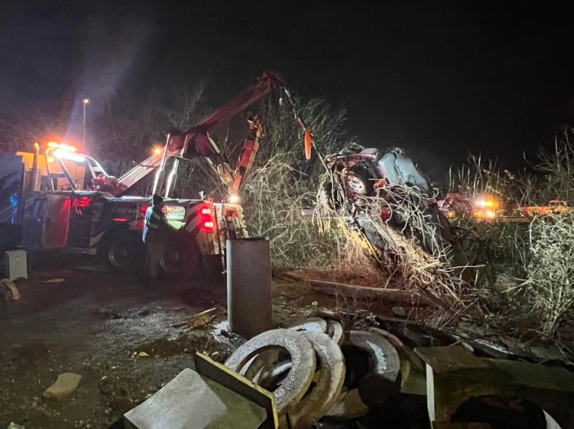 A Chevrolet Suburban being pulled from the Red River after officials believe it wrecked there early Sunday morning, Jan 17, 2022