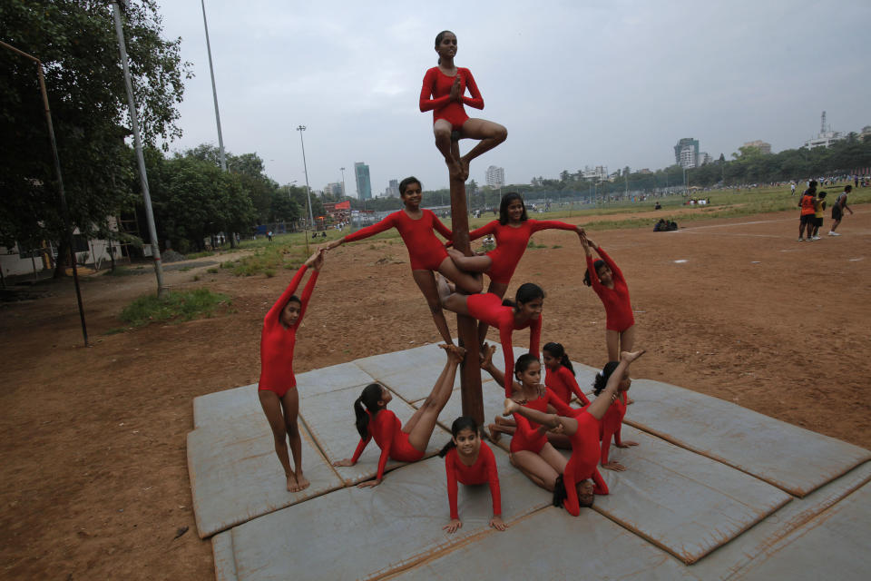 Girls practise a Mallakhamb "pyramid" pose in the shape of a crown while suspended at the Shree Samartha Vyayam Mandir in Mumbai