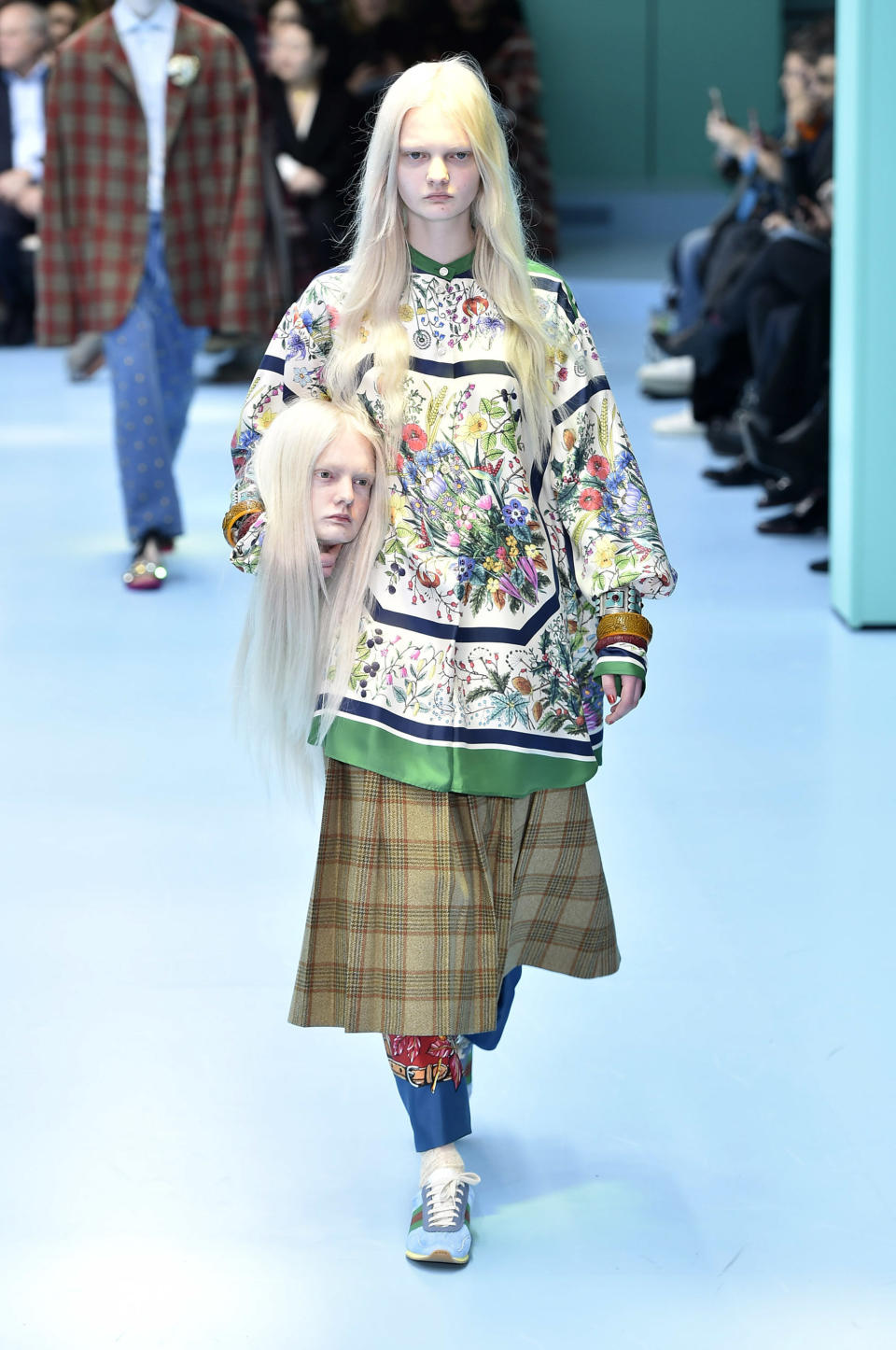 Talk about head-turning. At the Gucci show during Milan Fashion Week, a few models walked the runway holding fake heads modeled after their own.&nbsp;