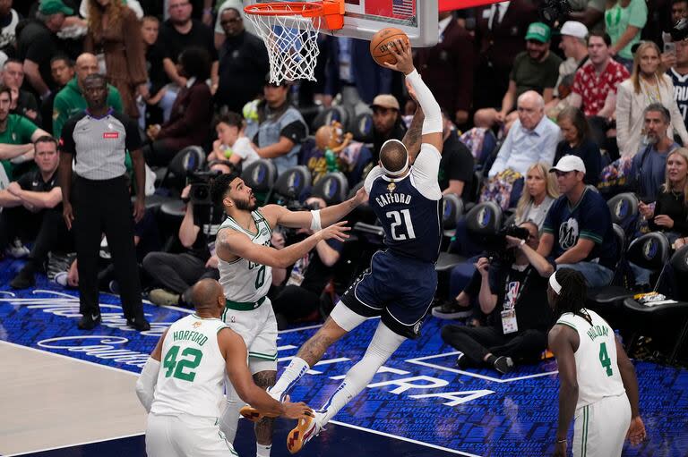 Daniel Gafford se apresta a puntuar frente a Jayson Tatum, que esta vez no fue lo productivo que suele sera para Boston Celtics; Dallas Mavericks ganó el cuarto partido, evitó la barrida en la final de la NBA y sigue teniendo esperanza.