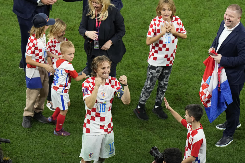 Croatia's Luka Modric, centre, celebrates after the World Cup quarterfinal soccer match between Croatia and Brazil, at the Education City Stadium in Al Rayyan, Qatar, Friday, Dec. 9, 2022. (AP Photo/Pavel Golovkin)