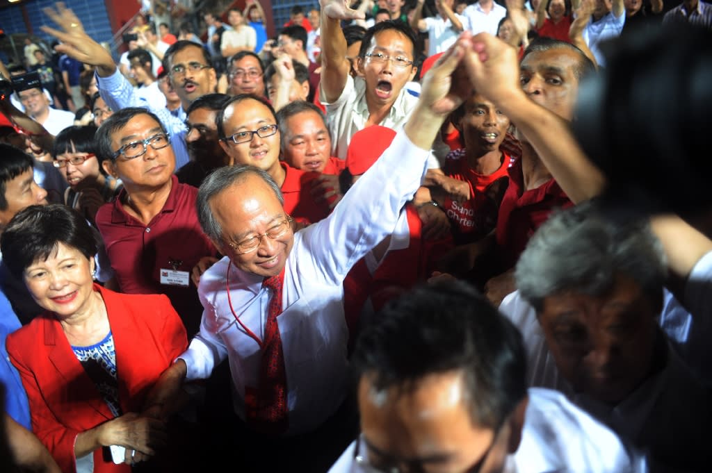 Singaporean presidential candidate Tan Cheng Bock (in red tie) greeting his supporters in 2011, when he stood as a candidate in the Presidential Election. (PHOTO: AFP)