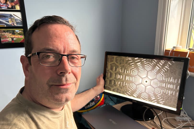 Thrifty dad Darren Leeming, 54, with a monitor he picked up from Facebook Marketplace
