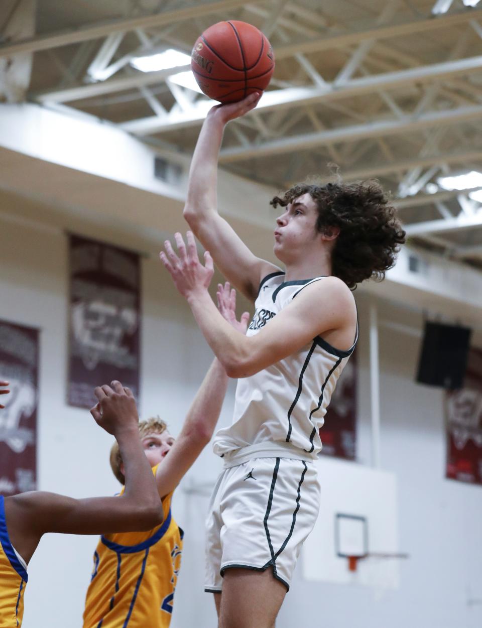 Holy Cross's Jacob Hand (11) shot against Kentucky Country Day defenders during the opening round of the Boys LIT at the Holy Cross High School in Louisville, Ky. on Jan. 9, 2023.  KCD won 60-52.