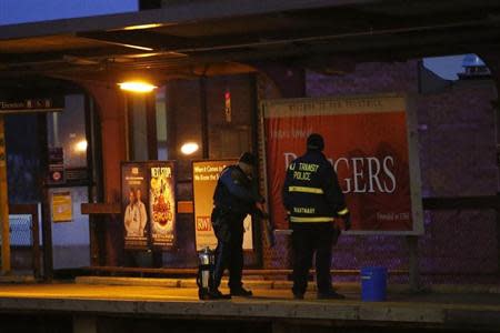 New Jersey Transit Police clean the New Brunswick station after an accident in New Brunswick, New Jersey, March 25, 2014. REUTERS/Eduardo Munoz