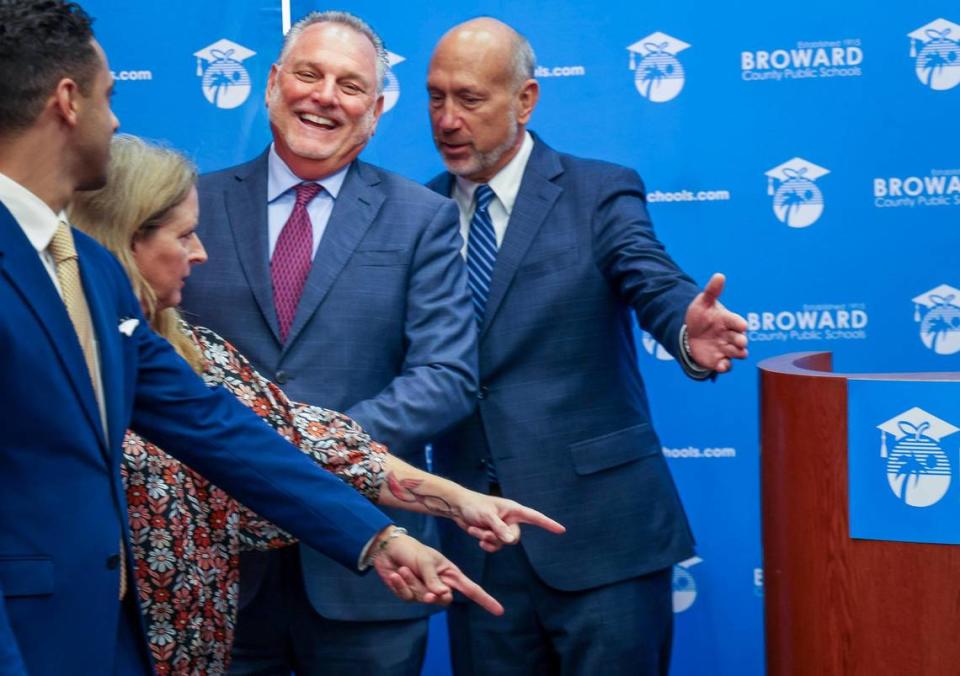 Superintendent Peter Licata, center, breaks into laughter as School Board members points to where he must stand for a group picture at the Kathleen C. Wright Building in Fort Lauderdale, Florida on Tuesday, July 11, 2023. Left to Right: School Board members Daniel Foganholi, Debra Hixon and Allen Zeman. On Tuesday, April 16, 2024, Licata announced his retirement. Carl Juste/cjuste@miamiherald.com