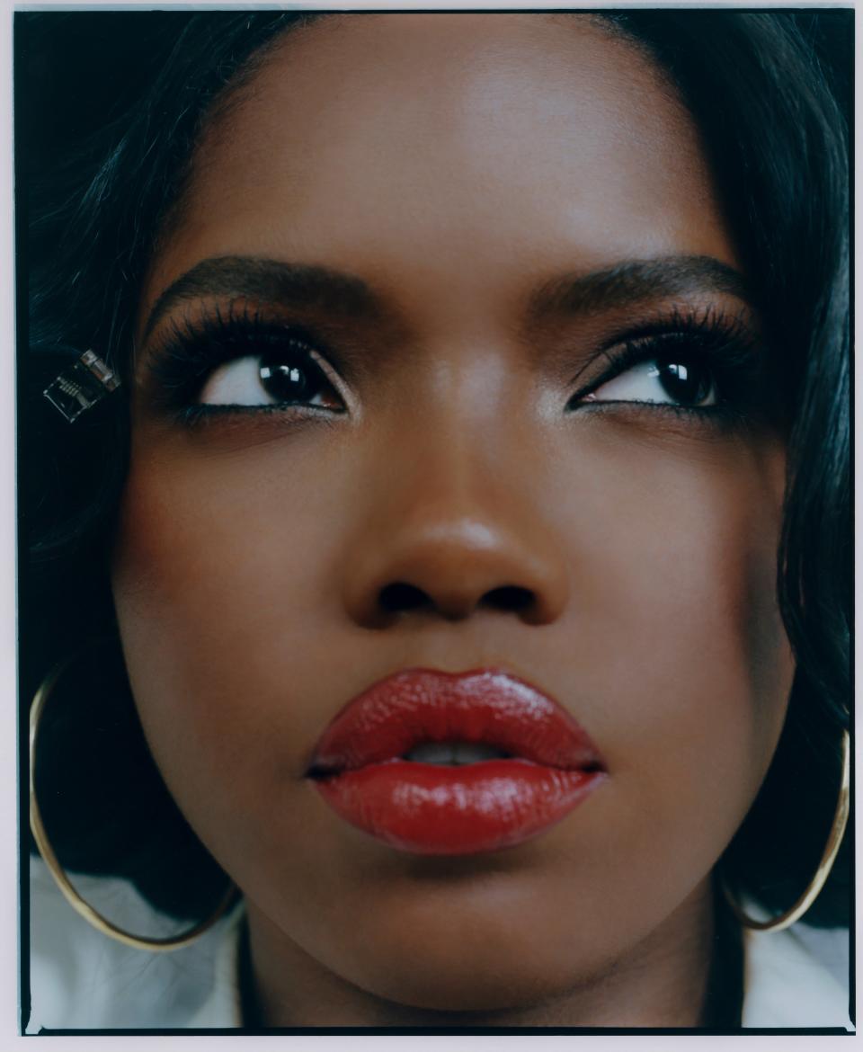 Ryan Destiny wears the Black Opal True Melanin 12-Well Eyeshadow Palette, Oil Absorbing Pressed Powder in Smokin' Topaz, and Colorsplurge Lipstick Creme formula in C-Suite.