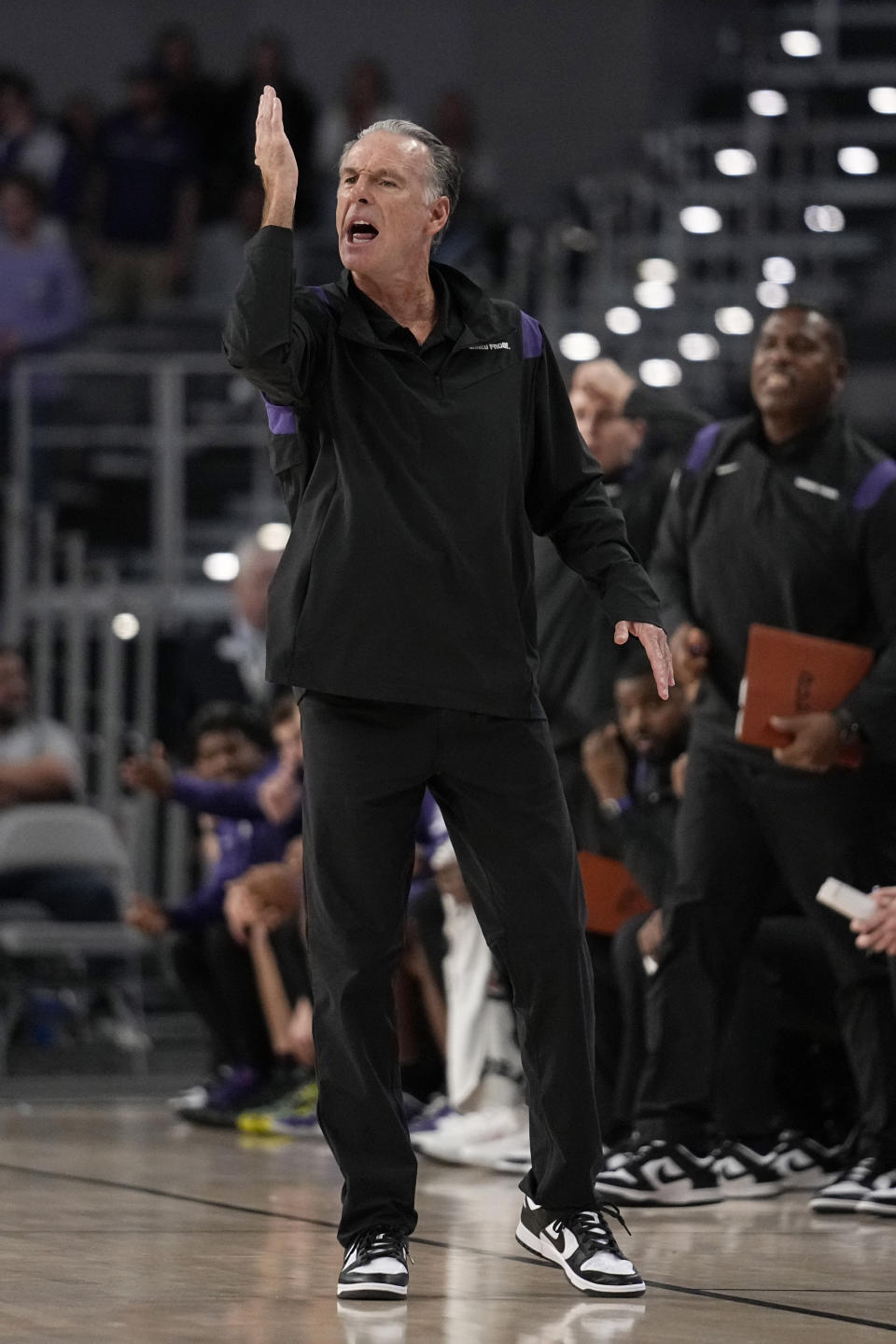 TCU head coach Jamie Dixon instructs his team in the first half of an NCAA college basketball game against SMU, Saturday, Dec. 10, 2022, in Fort Worth, Texas. (AP Photo/Tony Gutierrez)
