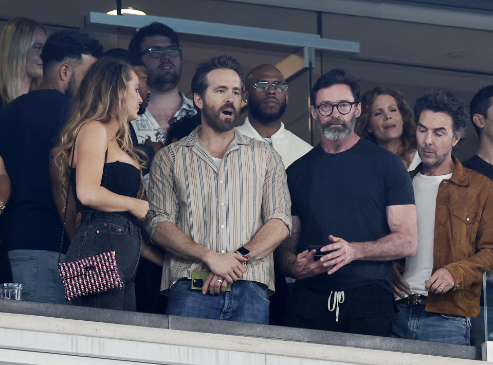 Blake Lively and Ryan Reynolds and Hugh Jackman attend a game between the New York Jets and the Kansas City Chiefs at MetLife Stadium