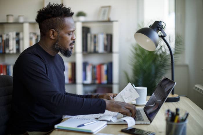 Man reviews his finances at his computer