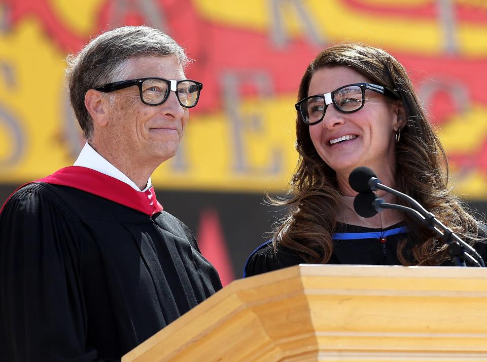 Bill Gates shares the stage with his wife Melinda during the 123rd Stanford commencement ceremony June 15, 2014 in Stanford, California