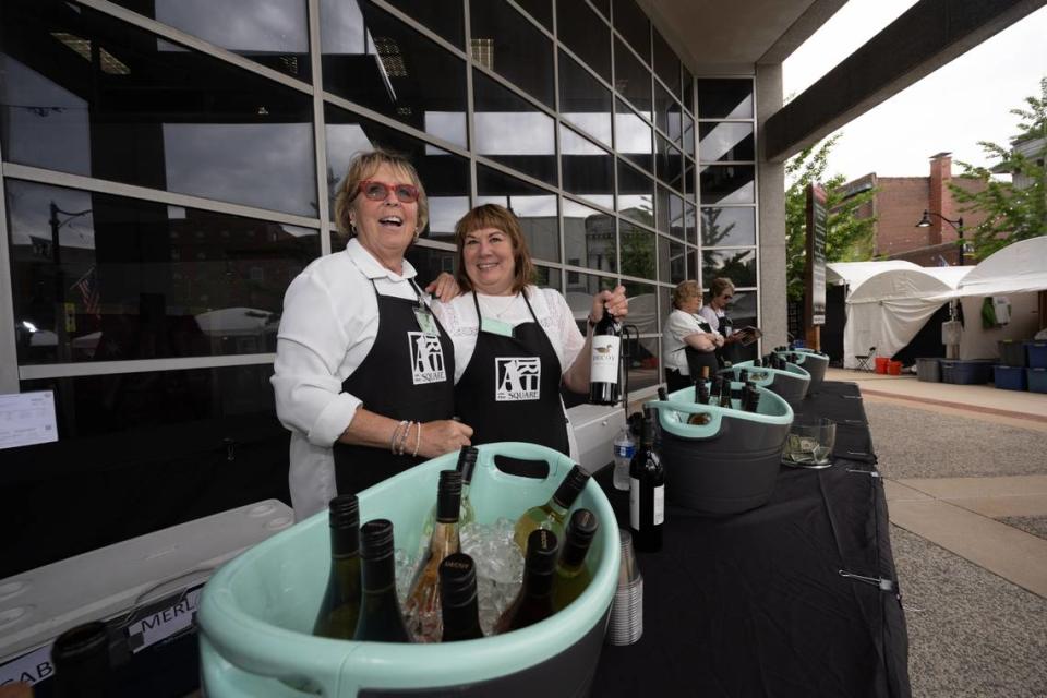Melissa Winkeler and Theresa Ackerman of Belleville pose while serving drinks during the first day of Belleville’s Art on the Square on May 17, 2024.