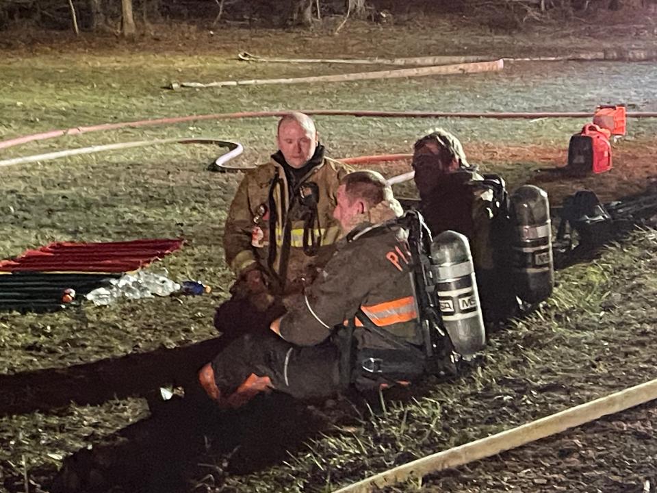 Fire personnel take a break after coming off of the fire line.