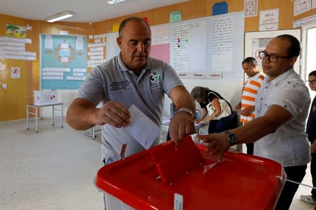 Man casts his ballot during a second round runoff of a presidential election in Tunis