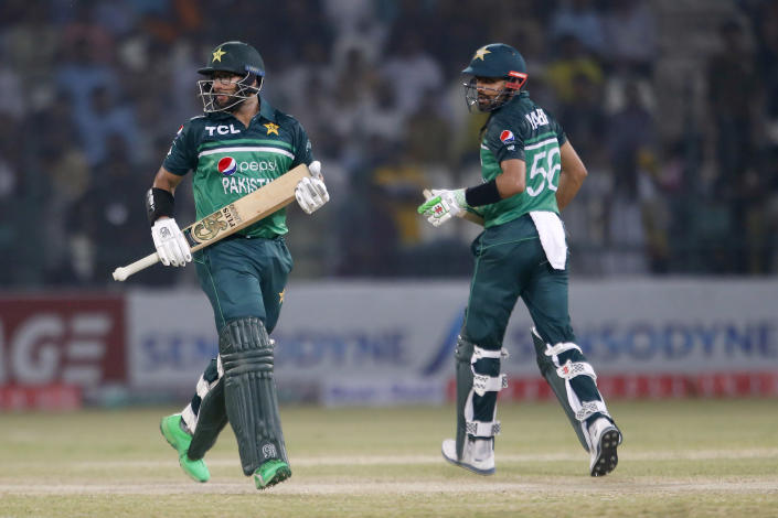 Pakistan's Imam-ul-Haq, left, and Babar Azam runs between the wickets during the first one day international cricket match between Pakistan and West Indies at the Multan Cricket Stadium, in Multan, Pakistan, Wednesday, June 8, 2022. (AP Photo/Anjum Naveed)