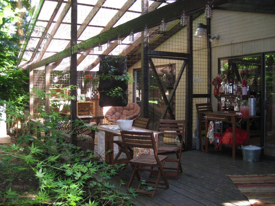 This undated photo provided by Carrie Fagerstrom shows Fagerstrom's catio at her home in Portland, Ore. The playground designed for her eight cats is a covered, enclosed patio attached to her house that includes scratching posts, a small water fountain and plenty of cat toys. She spent $5,000 on the catio, which allows her cats to be exposed to fresh air and scenery, but keeps them safe from harmful outdoor elements. (AP Photo, Carrie Fagerstrom)