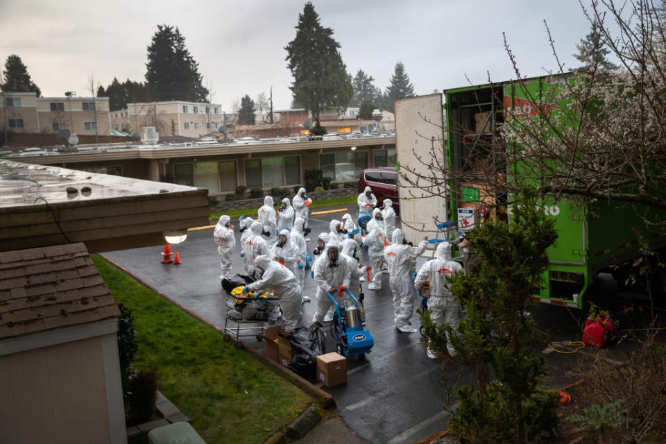 A cleaning crew suits up in protective clothing before entering the Life Care Center on March 12, 2020 in Kirkland, Washington. | Photo by John Moore—Getty Images