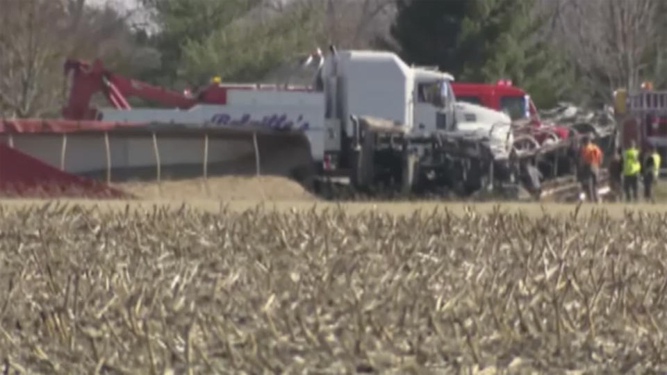 Emergency personnel work the scene of a crash on Monday, March 11, 2024 in Rushville, Ill. A bus from Schuyler-Industry Schools was traveling eastbound when “for an unknown reason” it crossed the center line on U.S. Route 24 into westbound lanes and into the path of a semitruck carrying sand, Illinois State Police said. (WICS via AP)