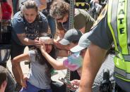 <p>People receive first-aid after a car accident ran into a crowd of protesters in Charlottesville, Va., on Aug. 12, 2017. (Photo: Paul J. Richards/AFP/Getty Images) </p>