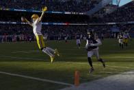 Green Bay Packers' Christian Watson reacts as he crosses the goal line after catching a touchdown pass during the second half of an NFL football game against the Chicago Bears Sunday, Dec. 4, 2022, in Chicago. (AP Photo/Charles Rex Arbogast)