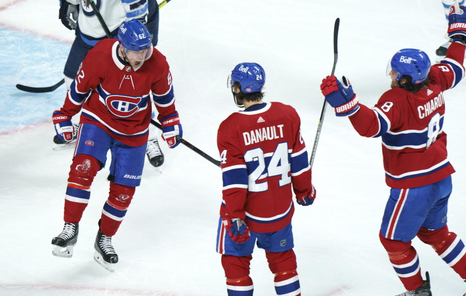 Montreal Canadiens' Artturi Lehkonen, left, celebrates his goal with teammates Phillip Danault and Ben Chiarot during the second period of an NHL Stanley Cup playoff hockey game in Montreal, Sunday, June 6, 2021. (Paul Chiasson/The Canadian Press via AP)
