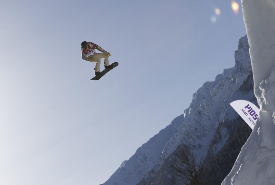 Shaun White of the United States takes a jump during a Snowboard Slopestyle training session at the Rosa Khutor Extreme Park, prior to the 2014 Winter Olympics, Tuesday, Feb. 4, 2014, in Krasnaya Polyana, Russia. (AP Photo/Andy Wong)