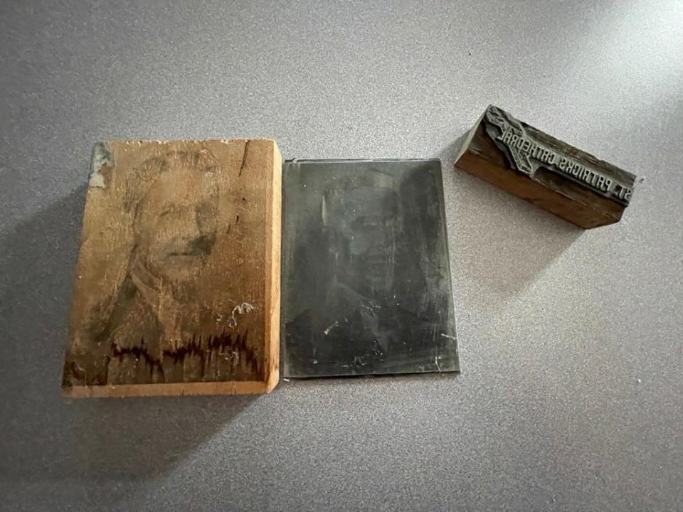 Relics of older printing technologies. One block is a graphic for St. Patrick's Cathedral, and the other is a photo of a man with the last name Zavistoski.