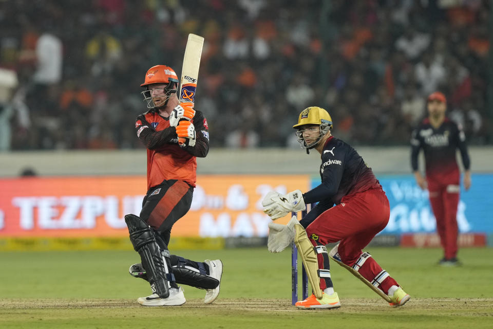 Sunrisers Hyderabads' Heinrich Klaasen plays a shot as Royal Challengers Bangalores' wicketkeeper Anuj Rawat watches during the Indian Premier League cricket match between Sunrisers Hyderabad and Royal Challengers Bangalore in Hyderabad, India, Thursday, May 18, 2023. (AP Photo/Mahesh Kumar A.)