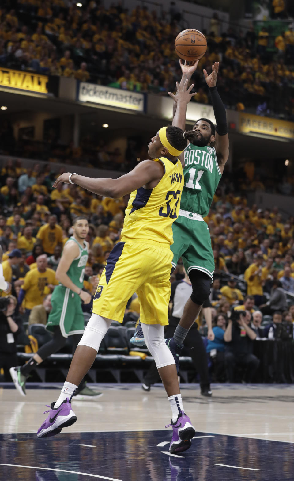 Boston Celtics guard Kyrie Irving (11) shoots over Indiana Pacers center Myles Turner (33) during the second half of Game 3 of an NBA basketball first-round playoff series Friday, April 19, 2019, in Indianapolis. (AP Photo/Darron Cummings)