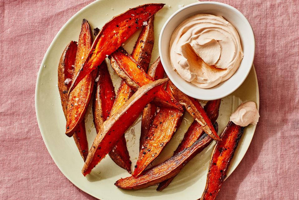 It takes just six ingredients to put together this snack or side dish: sweet potato wedges, olive oil, salt, black pepper, crème fraîche (or sour cream or mayonnaise), and sriracha. <a href="https://www.bonappetit.com/recipe/sweet-potato-fries?mbid=synd_yahoo_rss" rel="nofollow noopener" target="_blank" data-ylk="slk:See recipe.;elm:context_link;itc:0" class="link ">See recipe.</a>