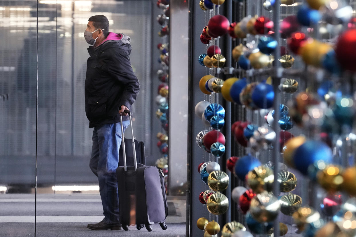 A traveler walks in Terminal 3 at O'Hare International Airport in Chicago, Monday, Dec. 19, 2022. (AP Photo/Nam Y. Huh)