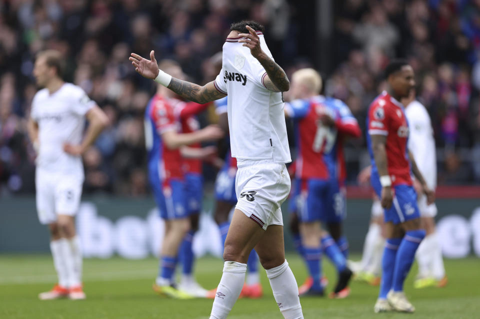 West Ham United's Emerson Palmieri, reacts after scoring an own goal to give Crystal Palace their third goal of the game during the English Premier League soccer match between West Ham United and Crystal Palace at Selhurst Park, London, Sunday April 21, 2024. (Steven Paston/PA via AP)