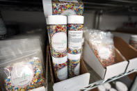 In this Tuesday, Aug. 13, 2019, photo sprinkles sit packaged on a shelf inside Sprinkle Pop, a company based in Houston that makes upscale sprinkles for bakers in Houston. (AP Photo/David J. Phillip)