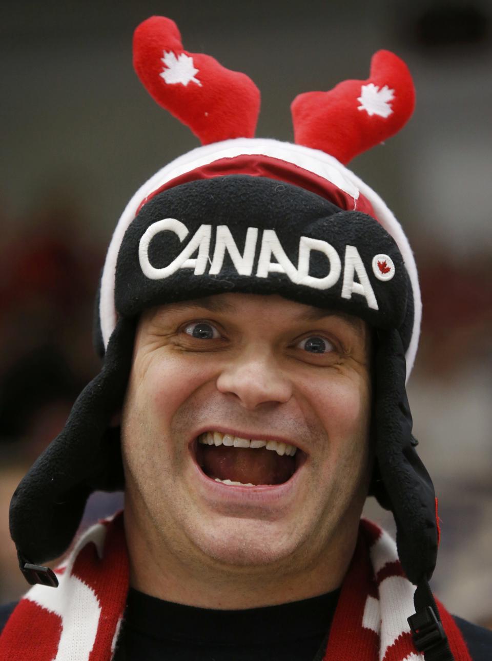 A Canadian supporter cheers before Canada plays the United States in their IIHF World Junior Championship ice hockey game in Malmo, Sweden, December 31, 2013. REUTERS/Alexander Demianchuk (SWEDEN - Tags: SPORT ICE HOCKEY)