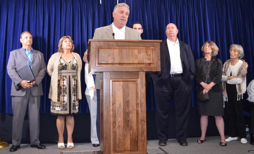 Bill McGinly of Vienna, Virginia, whose son, Mark, was killed in the Sept. 11, 2001, terrorist attack, talks to the media during a news conference at the U.S. naval base in Guantanamo, Cuba, April 17, 2014. McGinly expressed frustration at delays in the trial for five men facing trial by a military commission at Guantanamo Bay, Cuba, for their alleged roles orchestrating the attack. (AP PHOTO/Stijn Hustinx)