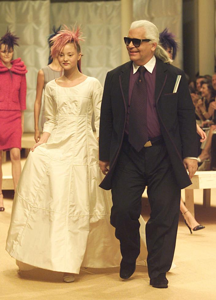 LAGERFELD AOKI German fashion designer Karl Lagerfeld, right, walks with Japanese top model Devon Aoki wearing the wedding gown after the presentation of the fall-winter 1999/2000 Haute Couture collection from Chanel Tuesday July 20,1999 in ParisFRANCE FASHION, PARIS, France