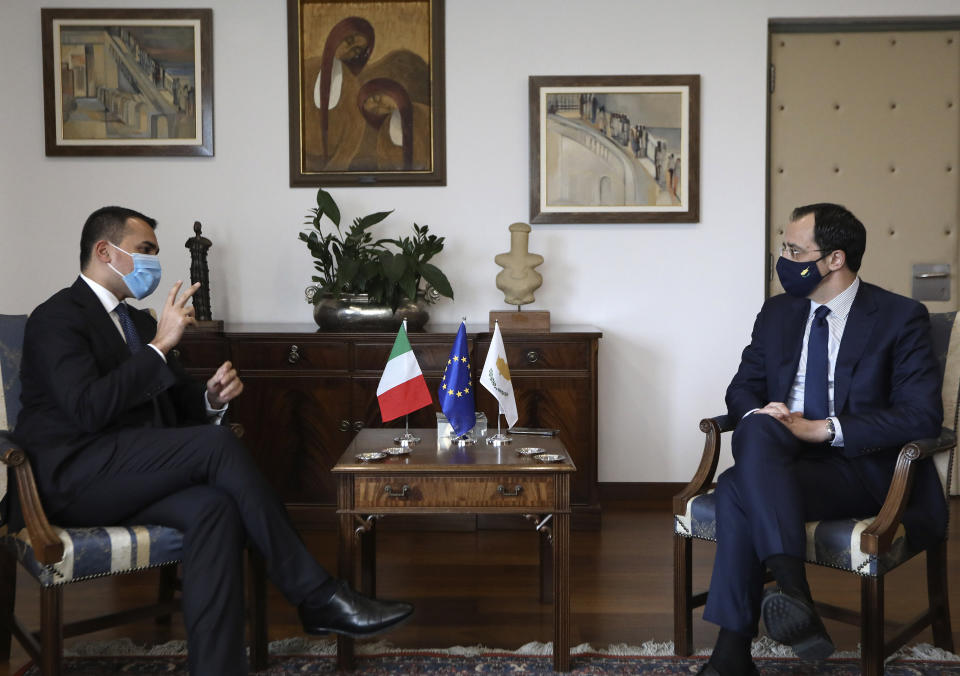 Cypriot Foreign Minister Nicos Christodoulides, right, and Italian Foreign Minister Luigi Di Maio talk during their meeting at the Foreign Ministry house in Nicosia, Cyprus, Tuesday March 9, 2021. Maio is in Cyprus for one-day visit. (Yiannis Kourtoglo/Pool via AP)