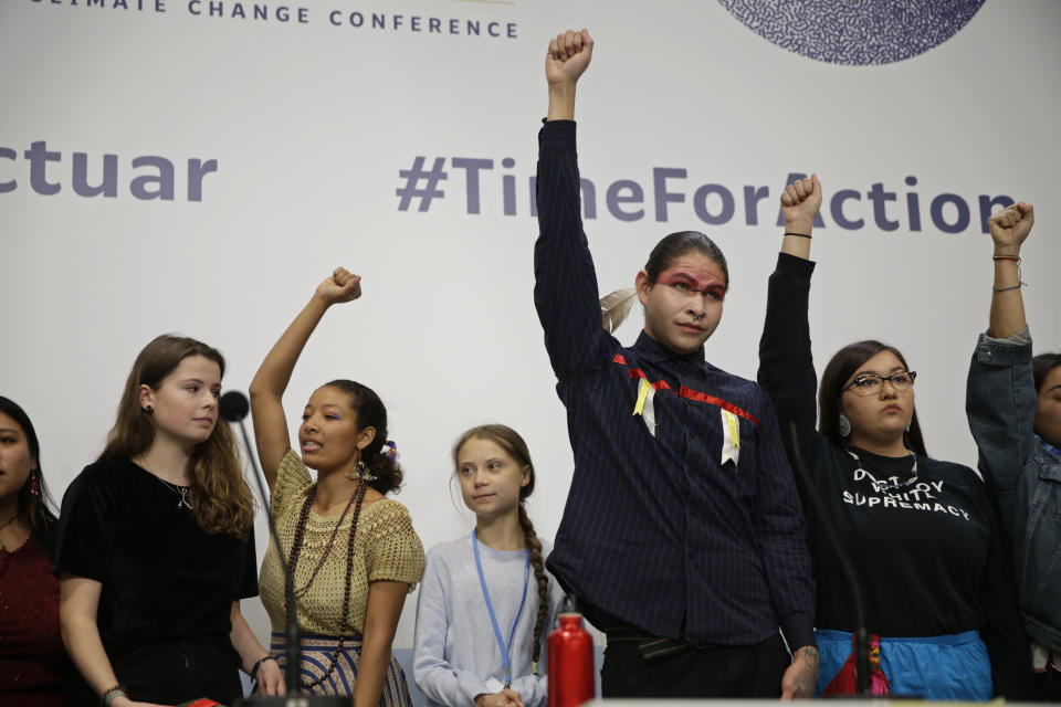 Climate activist Greta Thunberg, centre, stands with other young activists at the COP25 Climate summit in Madrid, Spain, Monday, Dec. 9, 2019. Thunberg is in Madrid where a global U.N. sponsored climate change conference is taking place. (AP Photo/Andrea Comas)