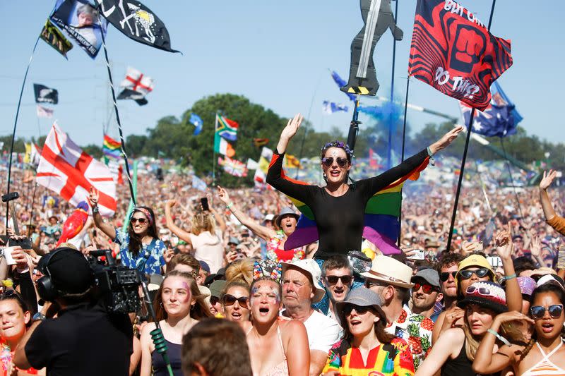 FILE PHOTO: Revellers watch Kylie Minougue perform Pyramid Stage during Glastonbury Festival in Somerset