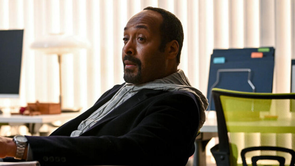  Jesse L. Martin sitting at desk as Alec in The Irrational. 