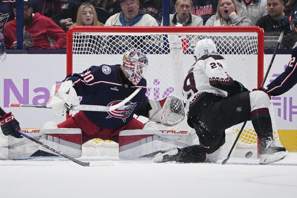 Arizona Coyotes center Barrett Hayton (29) scores on Columbus Blue Jackets goaltender Elvis Merzlikins, left, during the second period of an NHL hockey game Thursday, Nov. 16, 2023, in Columbus, Ohio. (AP Photo/Sue Ogrocki)