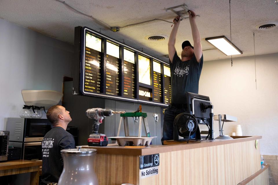 Kevin Dunford, left, and Tyrel Buchmeier remodel the interior of Tiki Taco Shack.