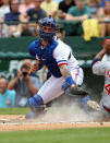 ARLINGTON, TX - MAY 12: Mike Napoli #25 for the Texas Rangers tries to tag out Howie Kendrick #47 of the Los Angeles Angels of Anaheim on May 12, 2012 in Arlington, Texas. Kendrick was safe on a dropped ball. The Angels won 4-2. (Photo by Layne Murdoch/Getty Images)